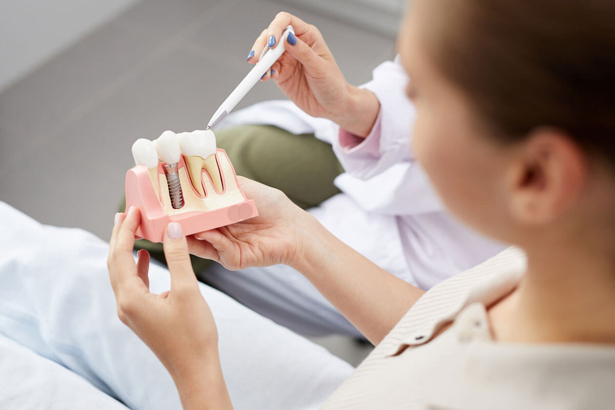 patient holding dental implant model