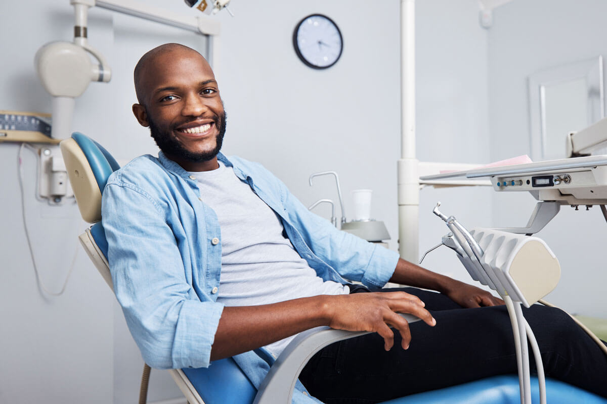 smiling man in dental examination chair