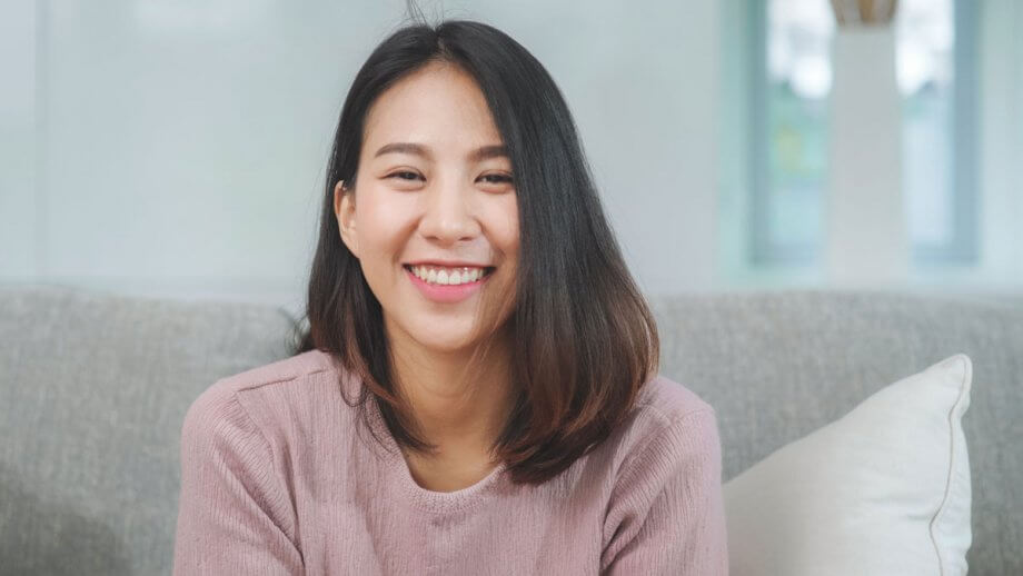 smiling teen girl sitting on couch