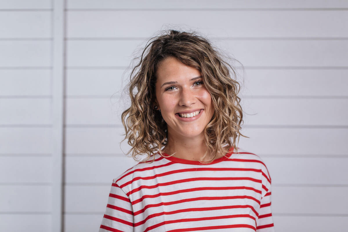 young smiling woman wearing red striped shirt