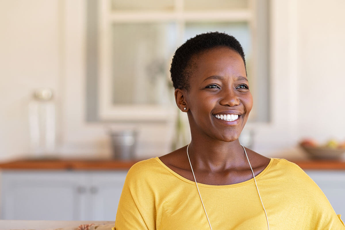 smiling woman wearing yellow shirt